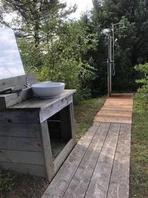a wooden counter with a sink on a wooden deck at Mazet avec piscine, vue Ventoux in Crillon-le-Brave