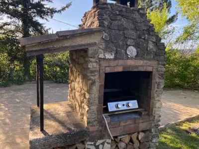 an outdoor brick oven with two controllers in it at Mazet avec piscine, vue Ventoux in Crillon-le-Brave