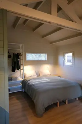 a bedroom with a large bed with a window at Rouleraventoux, Gîte sportif avec piscine, sauna, salle de sport, jardin in Mormoiron