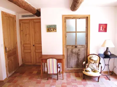 a room with a chair and a table with a stuffed animal at LUBERON - AIR CONDITIONING VILLA - 4 BEDROOMS - 4 BATHROOM in Lourmarin