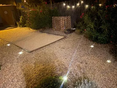 a garden at night with lights on the ground at Maison Plume en Provence in LʼIsle-sur-la-Sorgue