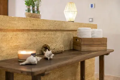 a table with a candle and two cats on it at Provencal farm with heated pool in Lamanon near Aix en Provence - 12 people in Lamanon
