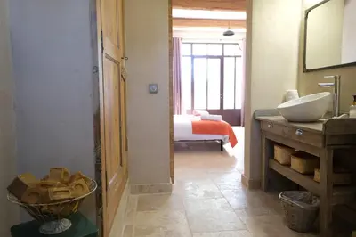 a bathroom with a sink and a bathroom with a bedroom at Provencal farm with heated pool in Lamanon near Aix en Provence - 12 people in Lamanon