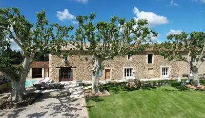 a large stone building with trees in the yard at Provencal farm with heated pool in Lamanon near Aix en Provence - 12 people in Lamanon