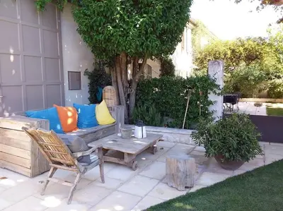 a patio with a couch and a coffee table at Charmant T1 calme et reposant in Saint-Andiol