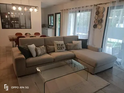 a living room with a couch and a table at Maison Neuf en Provence in Monteux