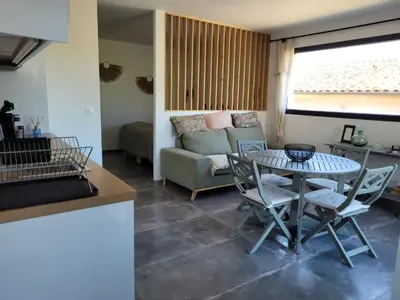 a living room with a table and a couch at Gîte au pied du mont ventoux in Bédoin