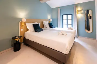 a bedroom with a large bed with a mirror at Château la Beaumetane in Lançon-Provence