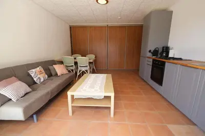 a living room with a couch and a table at Air-conditioned house in the Luberon with heated swimming pool in Saint Saturnin les Apt - 8 people. in Saint-Saturnin-les-Apt