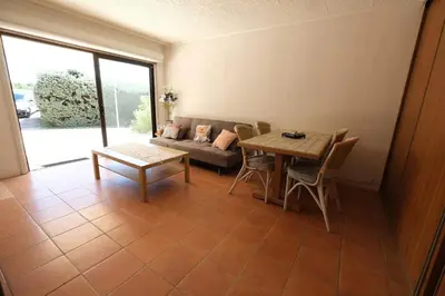 a living room with a table and a couch at Air-conditioned house in the Luberon with heated swimming pool in Saint Saturnin les Apt - 8 people. in Saint-Saturnin-les-Apt