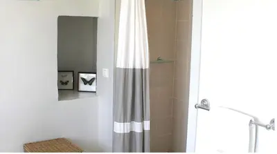 a bathroom with a shower with a shower curtain at ELIA HOUSE in Goult