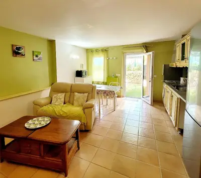 a living room with a couch and a table at Gîte de charme avec Piscine dans le Luberon au Domaine Artemiss in Apt