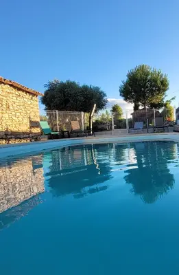 a swimming pool in a villa with blue water at Gîte de charme avec Piscine dans le Luberon au Domaine Artemiss in Apt