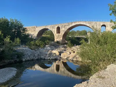 a bridge with two arches over a river at La Farigoulette - Vieux village in Saint-Saturnin-les-Apt
