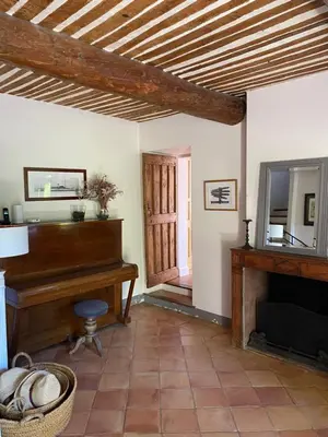 a living room with a piano and a fireplace at Mas provencal XIXème siécle avec piscine in Aix-en-Provence