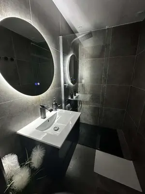 a living room with a mirror and a tile floor at DIMA SUITE Jacuzzi Privatif in Vedène