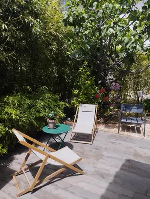 two chairs and a table and a chair at Studio Terrasse Privée Jardin Air conditionné in Aix-en-Provence