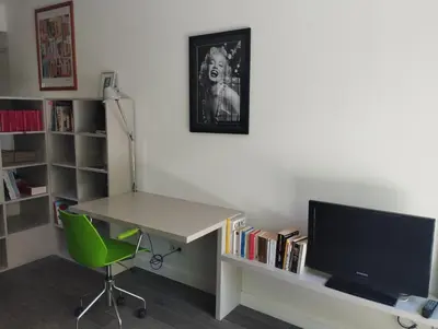 a room with a desk with a computer and a tv at Studio Terrasse Privée Jardin Air conditionné in Aix-en-Provence