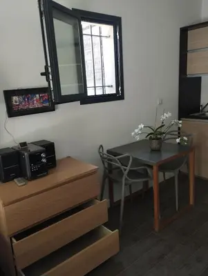 a table and a chair in a room with a mirror at Studio Terrasse Privée Jardin Air conditionné in Aix-en-Provence