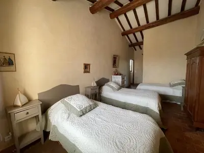 a bedroom with three beds in a room at Villa Helios in Rustrel