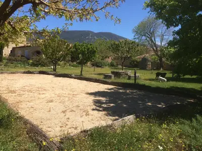a large dirt field with a horse in the grass at Villa Helios in Rustrel