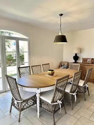 a dining room with a wooden table and chairs at Les Lauriers Roses air-conditioned villa with garden and swimming pool in Saumane-de-Vaucluse
