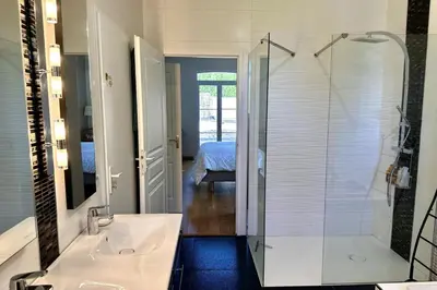 a bathroom with a glass shower and a sink at Les Lauriers Roses air-conditioned villa with garden and swimming pool in Saumane-de-Vaucluse