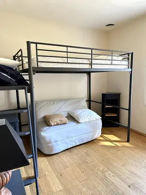 a bedroom with a bunk bed with a pillow on the floor at Les Lauriers Roses air-conditioned villa with garden and swimming pool in Saumane-de-Vaucluse