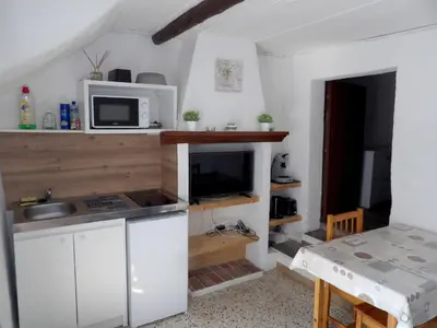 a kitchen with a sink and a microwave at Studio chez Steph in Eyguières