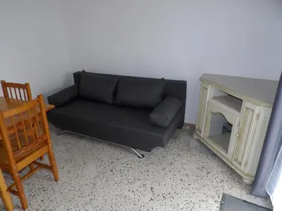 a living room with a couch and a table at Studio chez Steph in Eyguières