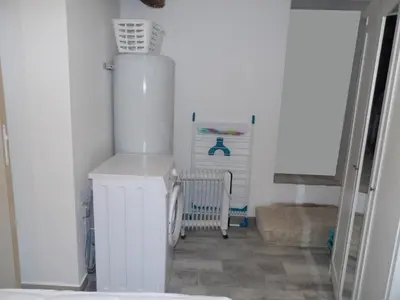 a room with a white refrigerator and a radiator at Studio chez Steph in Eyguières