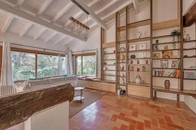 a large living room with wooden shelves and a large window at Grande villa avec piscine près d'Avignon - Jonquerettes in Jonquerettes
