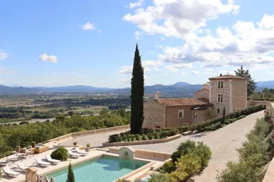an estate with a swimming pool in front of a building at Domaine Jourdan in Le Puy-Sainte-Réparade
