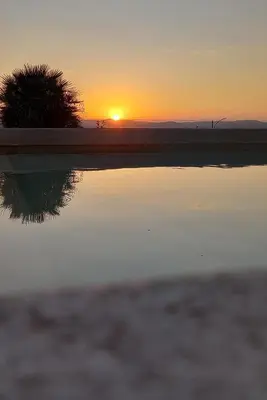 a reflection of the sunset in a pool of water at Domaine Jourdan in Le Puy-Sainte-Réparade
