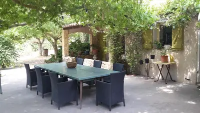 a blue table and chairs on a patio at Maison à Ansouis Luberon in Ansouis