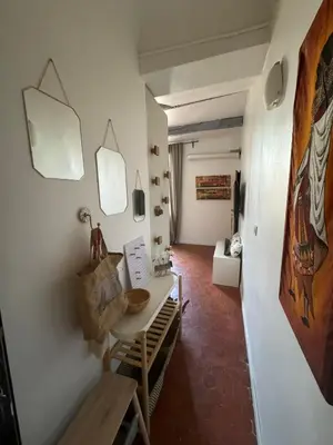 a dining room with a table and a room with a hallway at Cosy apartment Right in Cours Mirabeau in Aix-en-Provence