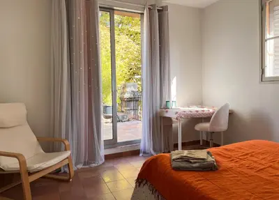 a bedroom with a bed and a table and a window at Aix center in Aix-en-Provence