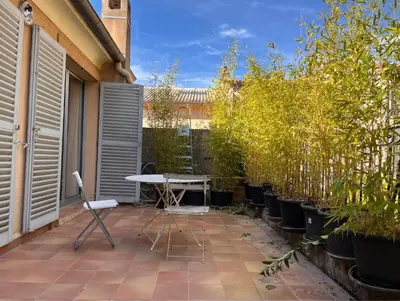 a patio with a table and some potted trees at Aix center in Aix-en-Provence
