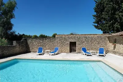 a group of chairs and a swimming pool at Provencal Farm with swimming pool near Isle sur la Sorgue - 10 people. in Les Vignères