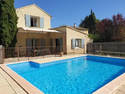 a large blue swimming pool in front of a house at Provence Gîte de caractère à MONTEUX entre AVIGNON LUBERON Mt VENTOUX in Monteux