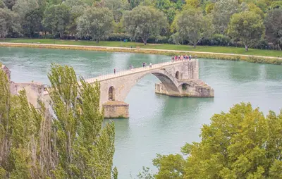a group of people crossing a bridge over a river at Provence Gîte de caractère à MONTEUX entre AVIGNON LUBERON Mt VENTOUX in Monteux