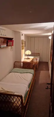 a room with two bunk beds and a table at Le Jardin secret 100m Mairie in Aix-en-Provence