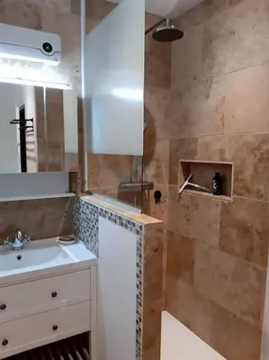 a bathroom with a sink and a shower at Appartement Au Murmure des Eaux à Fontaine-de-Vaucluse in Fontaine-de-Vaucluse
