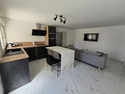 a kitchen and living room with a couch and a table at Pic chic in Châteaurenard