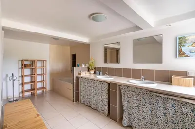 a large bathroom with two sinks and a tub at La Grange des Davids Mas en Provence in Oppedette