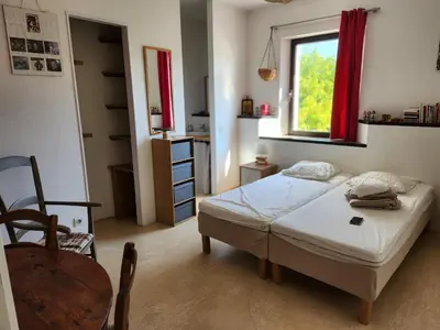 a small bedroom with a bed and a window at Mas des Grialou, grand mas provencal de standing in Carpentras