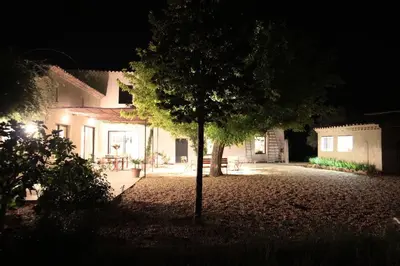 a tree in front of a house at night at Mas des Grialou, grand mas provencal de standing in Carpentras