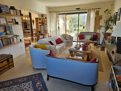 a living room with couches and a coffee table at Mas des Grialou, grand mas provencal de standing in Carpentras