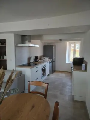 a kitchen with a table and a dining room at Maison dans le luberon in Viens