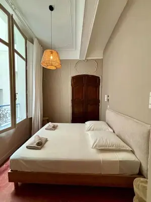 a bedroom with a white bed with a lamp at Splendide T2 au coeur d'Aix et du Cours Mirabeau in Aix-en-Provence